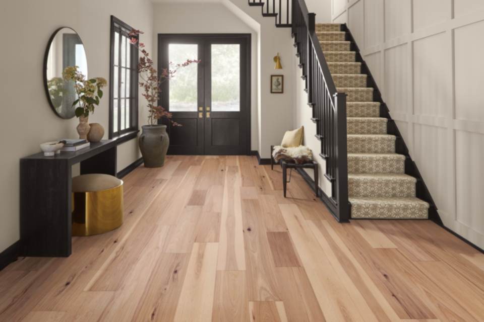 warm toned hardwood flooring in entryway.